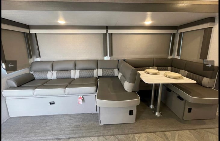 Lounger with dinette set up in a L-shaped table .