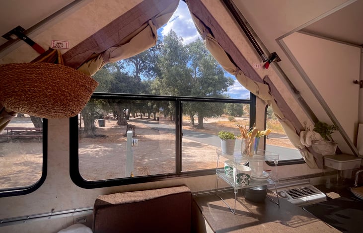 Lots of natural light and space in the Aliner pop top rental at KOA Boulevard