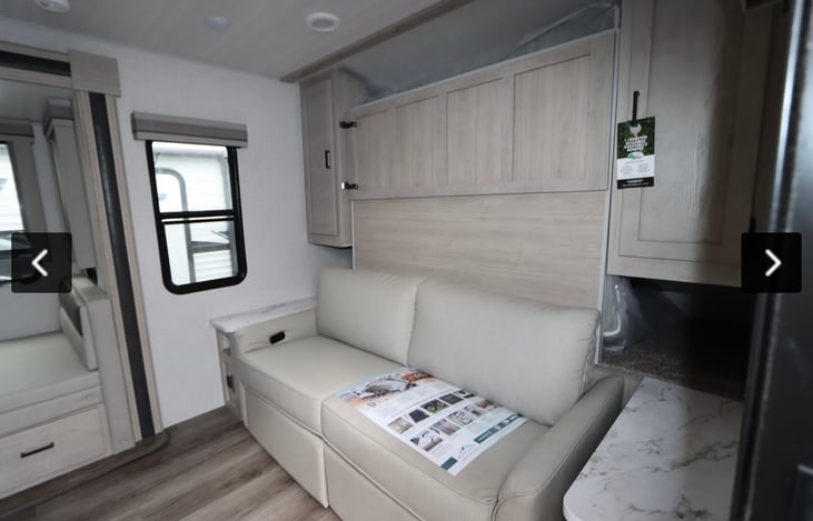 Queen murphy bed behind the couch.