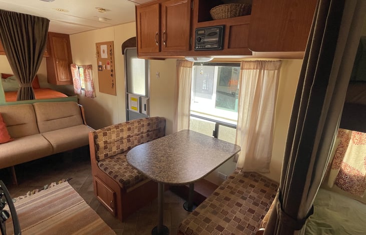 Dinette area.
If needed, the table can sink down and the cushions pulled down to rearrange the dinette into another sleeping space