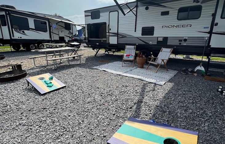 Outdoor set up package includes chairs, rug, table and cornhole for an additional fee.