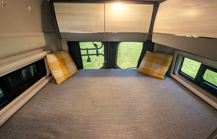 Comfortable bed in the back with storage cubbies all around.