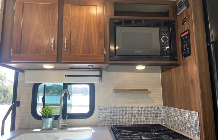 Full size sink, large microwave, and a gas stovetop