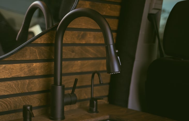 The van includes a water heater for warm water, along with dishwashing soap and a water filter for everyday comfort and convenience.