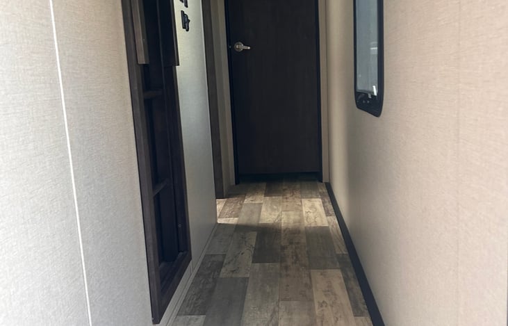 Hallway leads to loft, bathroom and master bedroom