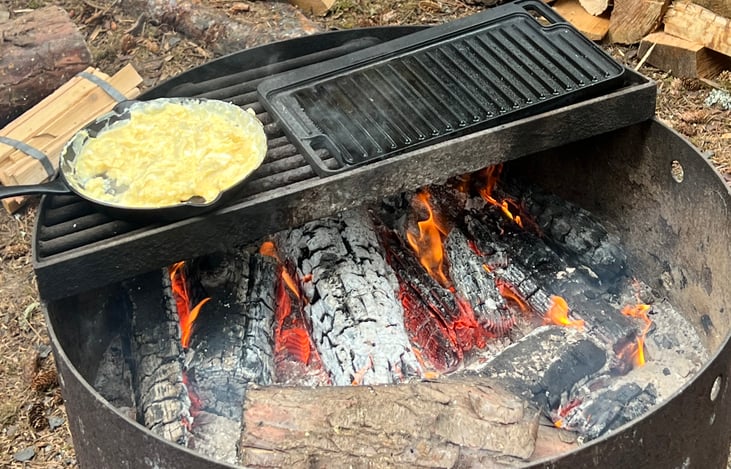Wood fire scrambled eggs on cast iron.