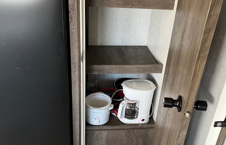 Large pantry, complete with a crockpot, coffee maker and cookware