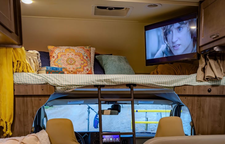 Overhead bunk is great for the kids (ours LOVE it). TV swings out for use our stays tucked away. P.S. The bunkhouse is plenty roomy enough for an adult!