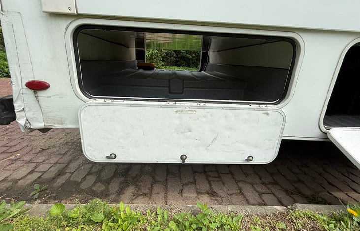 This is the passenger side of the basement. We store the 5 camping chairs, Coleman Stove, and table here. You can remove them or take them with you. We are completely flexible.