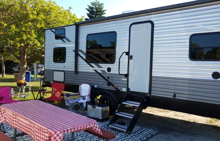 Exterior with awning in. Each bunk has it own window.