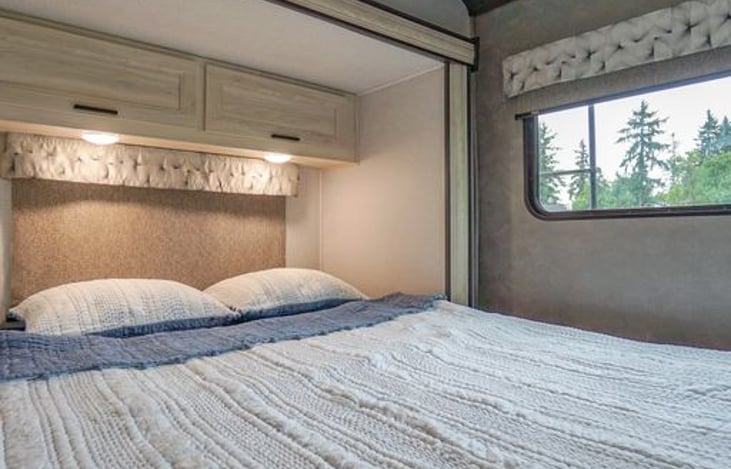 Slide out with queen bed. Cotton quilt. We will add down comforter for the colder seasons!