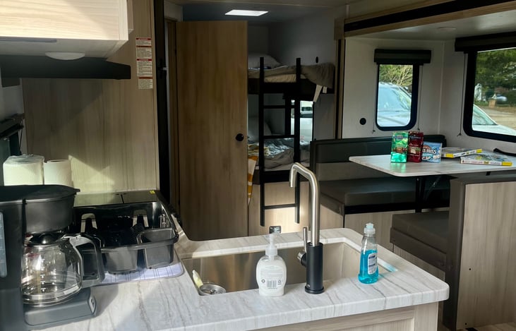 Main entrance. Kitchenette includes coffee pot, complementary coffee, and fully stocked with dish ware, silverware, and cooking utensils!