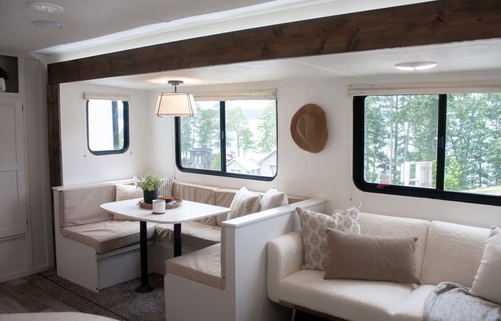 Featuring a cozy futon, a versatile dinette, and a spacious pantry, this space is designed to accommodate your relaxation, dining, and storage needs with style.