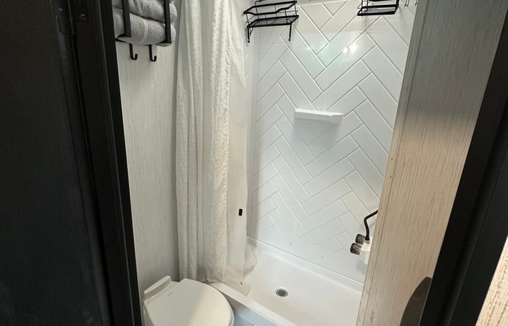 Main bathroom & Shower. The shower has a folding/expanding shower curtain rod for more space in the shower. Upgraded shower head!