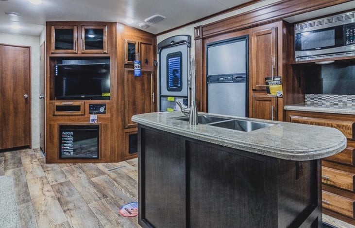 Full view of the kitchen and entertainment area