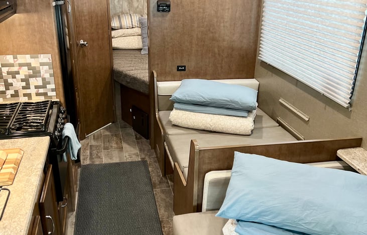 Dining and couch fold out for children to sleep, bottom sheet, comforter, and pillow provided