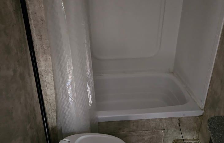 Shower head has an on/off button to conserve water when boondocking.