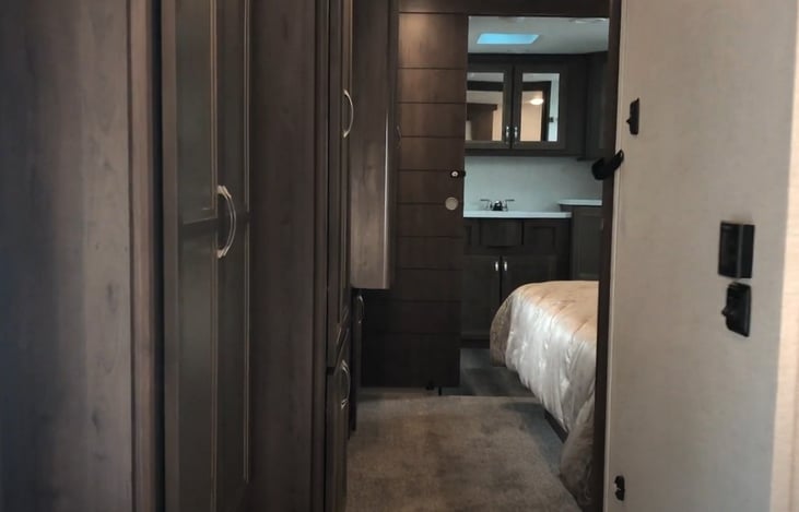 Looking to bedroom and bathroom from hallway