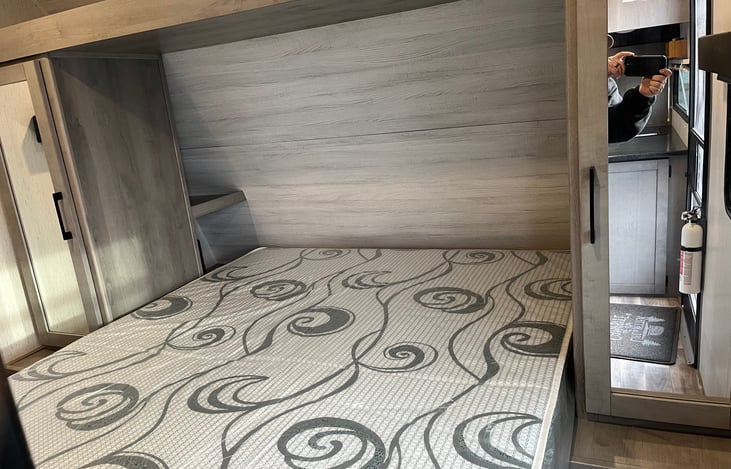 Queen size bed in master bedroom.