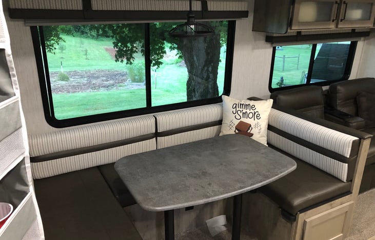 dinette with room for 6 to eat also lays down to full size bed