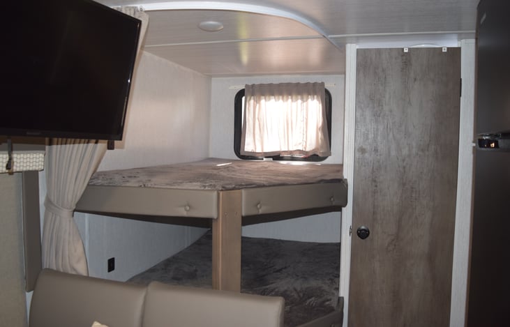 Privacy Curtain pulled back showing bunks.