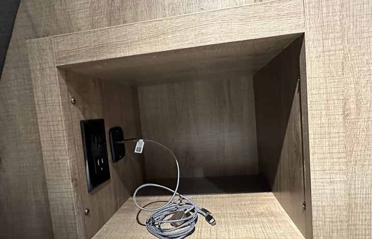 The master bedroom is equipped with cubbies on both sides of the bed, each stocked with extra chargers. Just in case you forgot yours