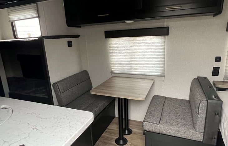 Seating for 2-4. Overhead storage and storage beneath the seating.