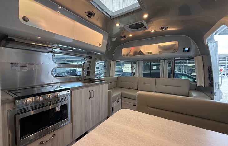 Skylight brings in extra light to common area. You can see the sofa lounge and kitchen in this picture. The radio control can be seen in top right near overhead storage.