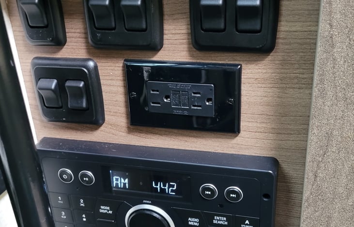 Light switches, stereo, DVD and handy outlet.