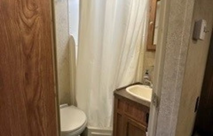 Fully functioning and comfortable shower. We only ask that you not flush any paper at all into the tank.  There is a sanitary trash can with liners to dispose of paper.