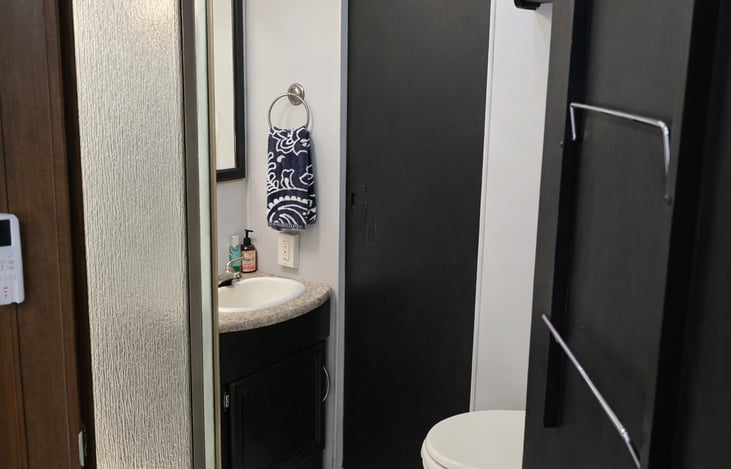 Bathroom with shower, fully stocked at no additional cost with shower gel, lotion, sunscreen, RV toilet tissue, a first aid kit, and other essentials