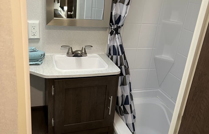 Bathroom has small tub and shower