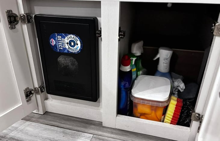 A tidy under‑sink cabinet stocked with cleaning essentials, giving renters everything they need to keep the space fresh during their stay.