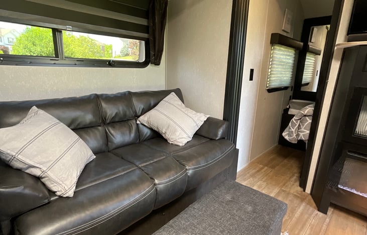 Living room facing Master bedroom. Sliding doors are on either side of the Master bedroom entrance. Mirrored closets, power outlets and USB ports  are also on either side of the bed.