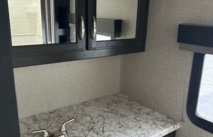 Bathroom: Spacious rear bathroom with a large vanity area for extra counter space.