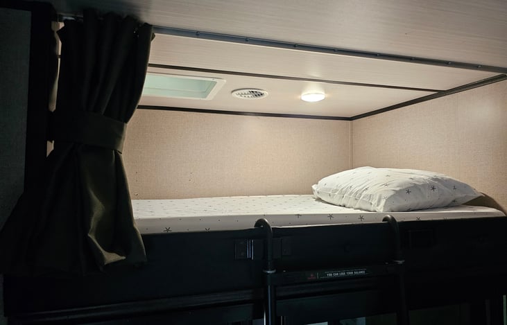 Above sliding door bunk twin bed with safety rail