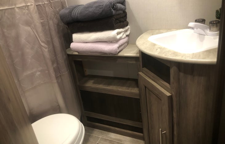 Bathroom sink, toilet, shelf/counter.  Linens are included in rent