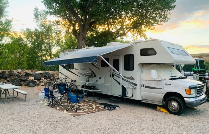 Outside very with fully functioning awning. This package includes the use of the "basement" which has four chairs, gas firepit, tank of propane, extra table and ground mat.