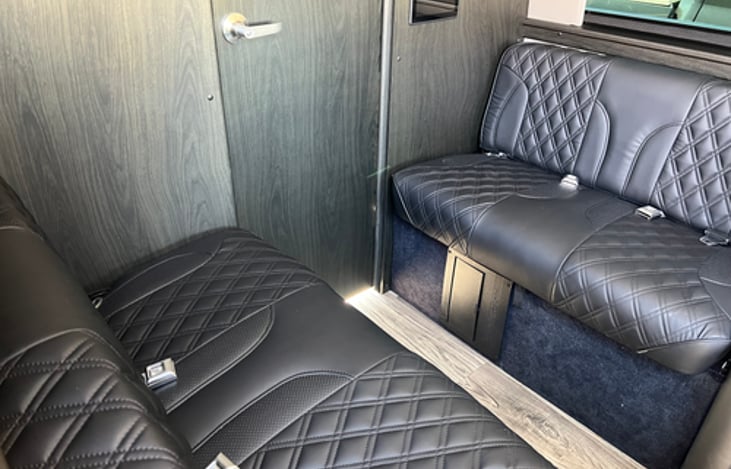 2 bench seats that has 4 seat belts but could fit 6 children or small adults