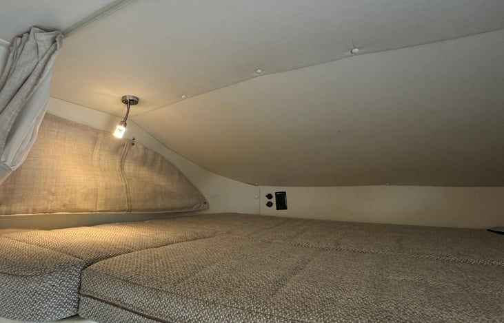 Overcab full size bed with lighting and electrical ports