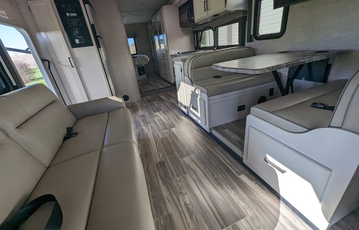 Spacious living area with couch and dining table