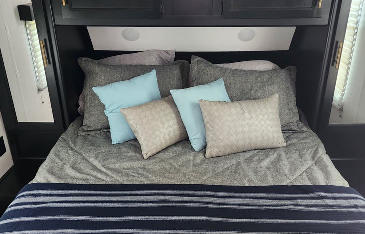 upgraded mattress for comfy sleeping! This is our queen-size bed in the bedroom!