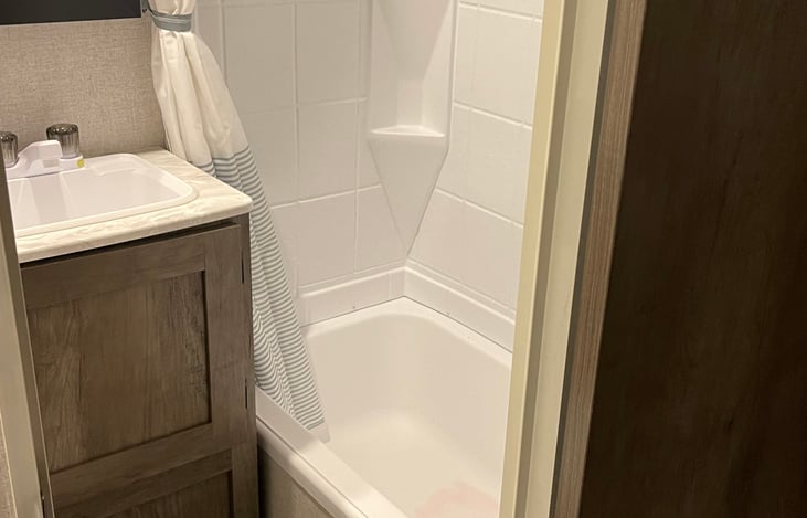 The bathroom is where you can become the cleanest you’ve ever been; featuring a stand up shower with hot  and cold water.  If you  prefer  you can put the plug in and relax with a nice bath.