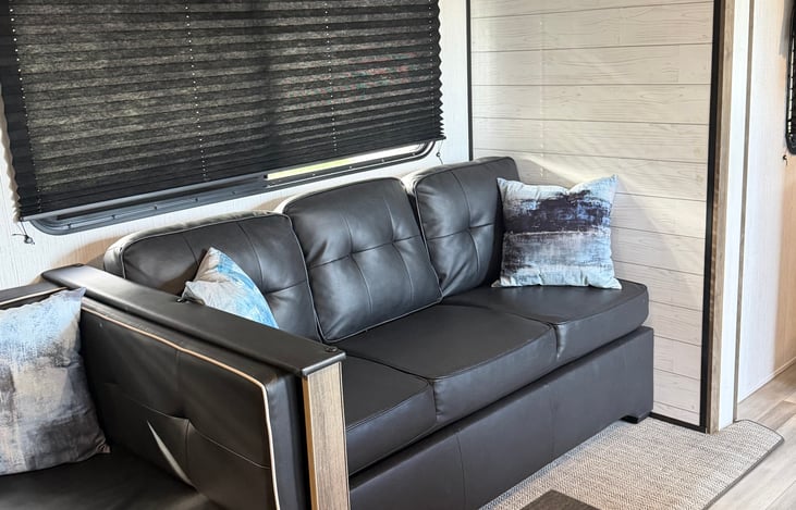 Sleeper sofa with folding down cup holders and storage under