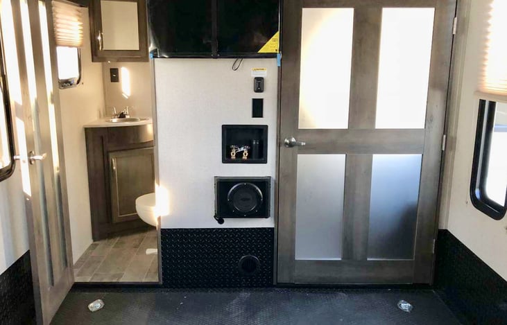 Half bathroom in the garage area with 32in TV.