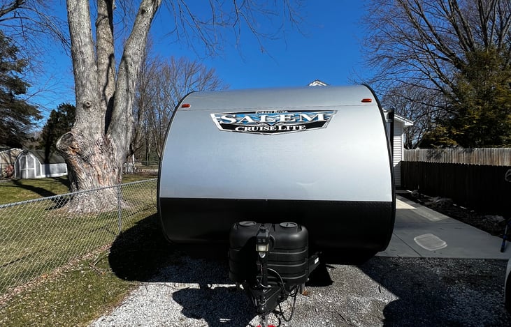 Front. Two propane tanks, electric jack.