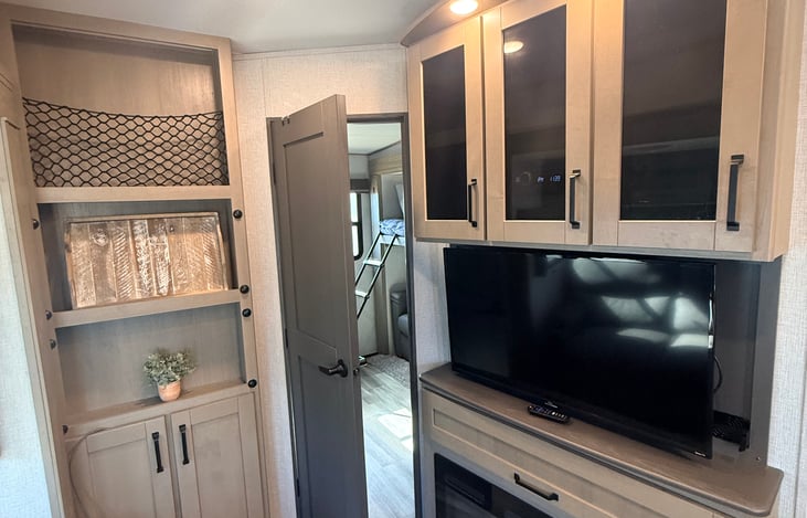 Entertainment system - radio, DVD player, TV, and electric fireplace.