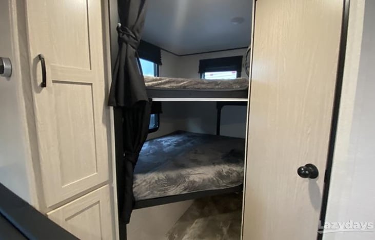 Bunk beds next to pantry cabinet