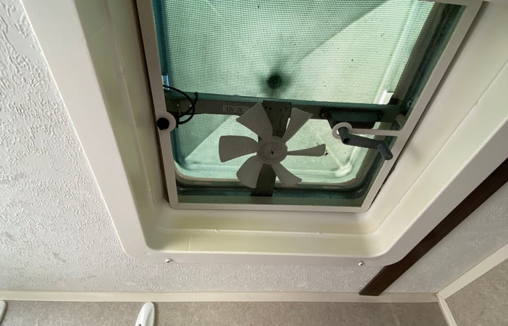 Bathroom fan and crank for vent