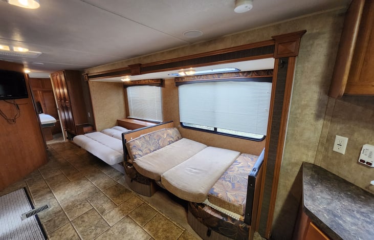 Jack knife sofa and dinette cushions in bed arrangement.